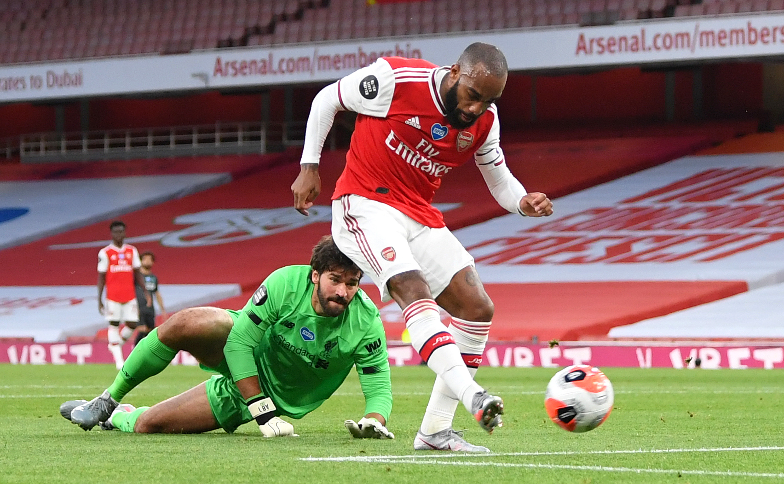 SLØVT FORSVARSSPILL: Alexandre Lacazette scorer Arsenals første mål etter å ha rundet Alisson Becker.